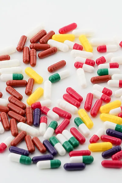 Assorted capsules on white background