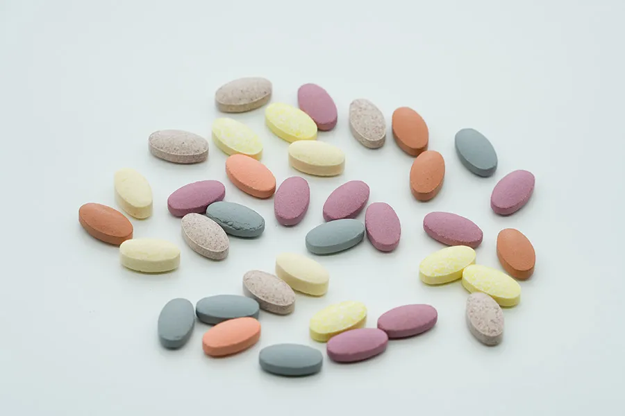 Assorted color tablets on white background
